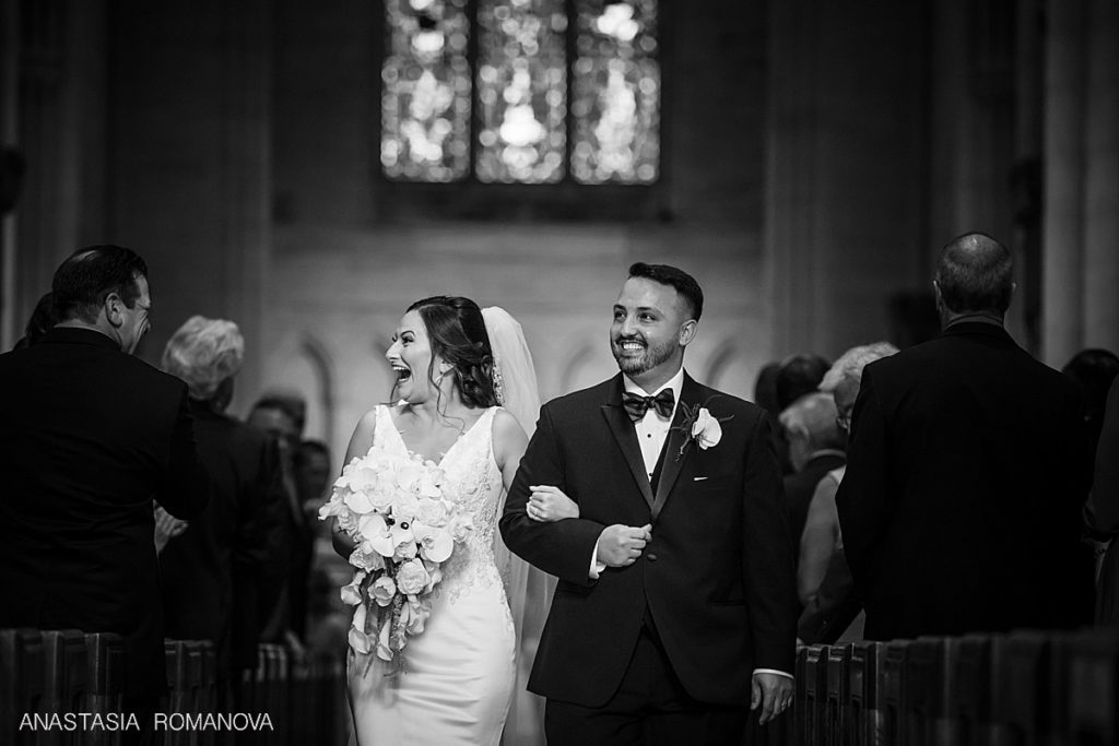 bride is smiling happily at Bryn Athun Cathedral