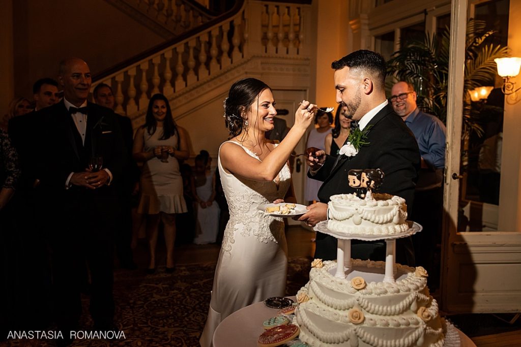 bride and groom are cutting the cake at Cairnwood Estate wedding