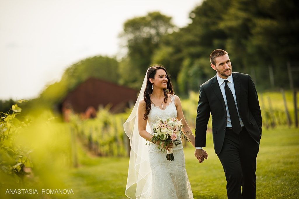 Bride and groom walking holding  hands at Crossing Vineyards wedding