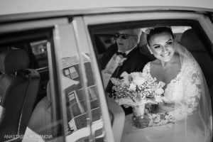 Bride leaving fro teh ceremony in a Rolls Royce with her dad
