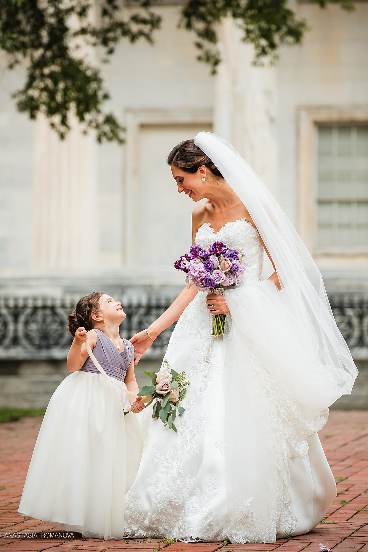 Bride and flower girl sharing a moment at Philly wedding