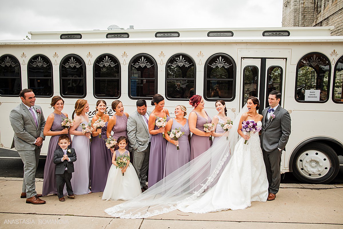 Bridal party photo in front of the wedding trolley