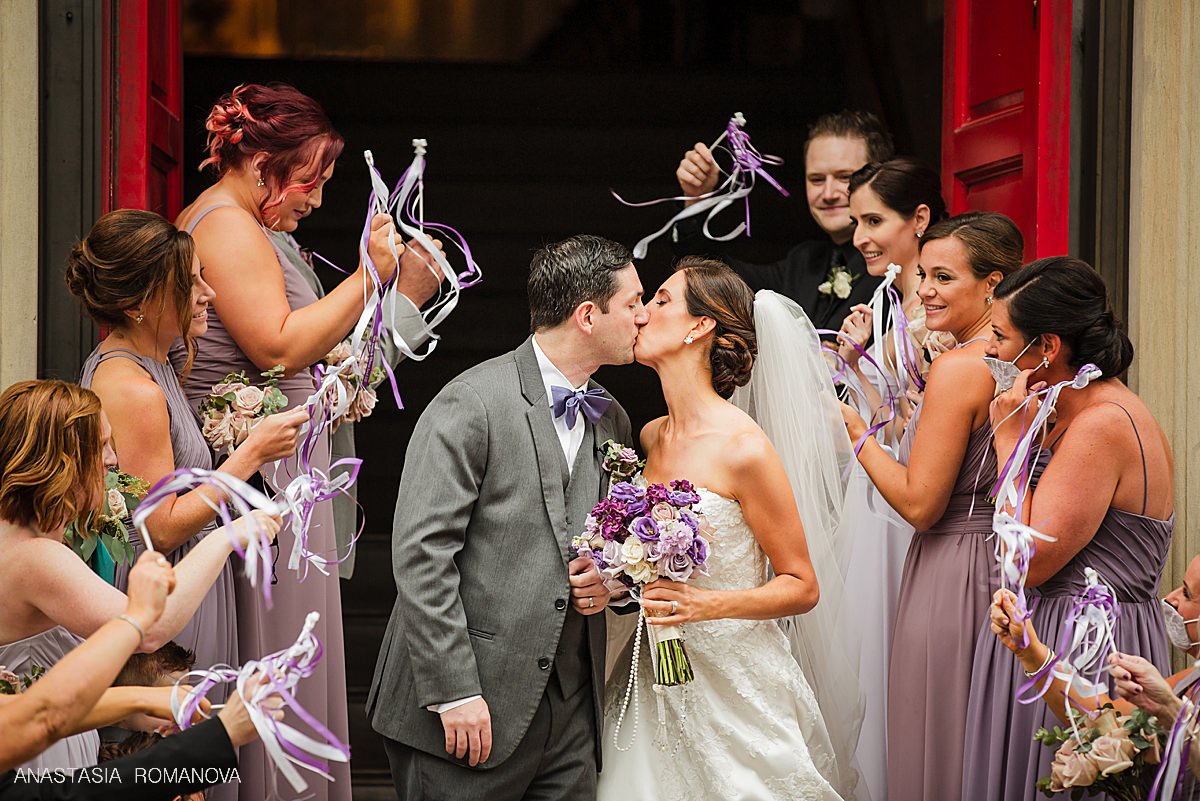 Bride and groom kissing during church exit at Sy Augustine Church in Philadelphia