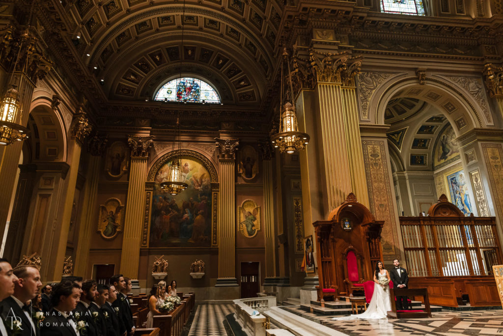 Wide angle view of the wedding ceremony at Cathedral Basilica of Saint Pater and Paul in Philadelphia