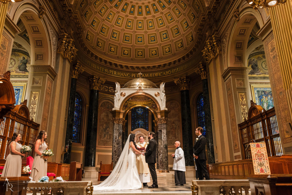 Wide angle view of the wedding ceremony vow exchange at Cathedral Basilica of Saint Peter and Paul in Philly
