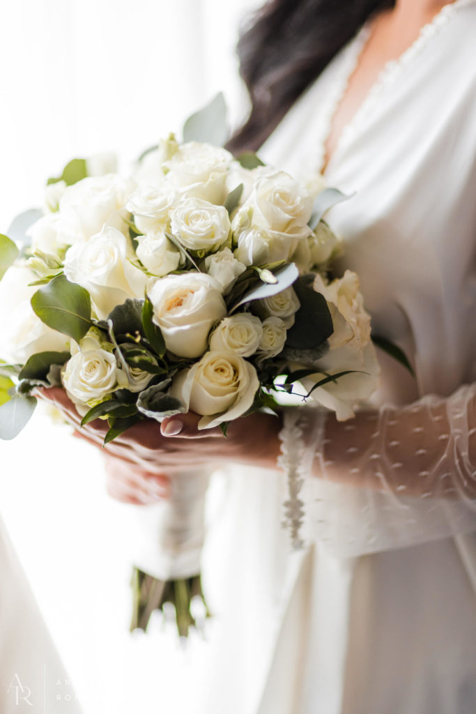 Bride holding a white rose bouquet at Logan Hotel Philadlephia